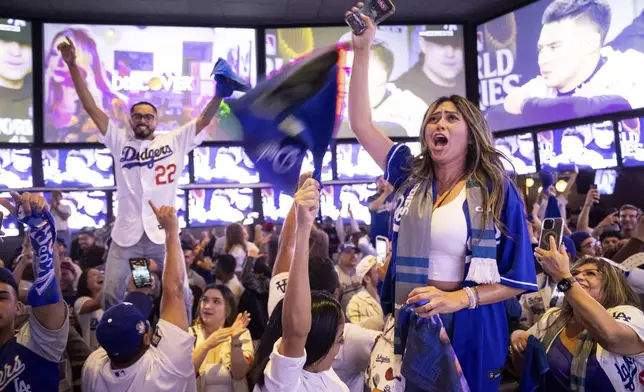 Fans celebrate after the Los Angeles Dodgers won against the New York Yankees in the baseball World Series Wednesday, Oct. 30, 2024, in Los Angeles.