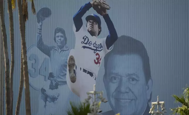 A mural is displayed of Los Angeles Dodgers legend Fernando Valenzuela at Dodger Stadium Thursday, Oct. 24, 2024, in Los Angeles. Valenzuela died Tuesday at age 63. The New York Yankees face the Dodgers in Game 1 of the baseball World Series Friday. (AP Photo/Julio Cortez)