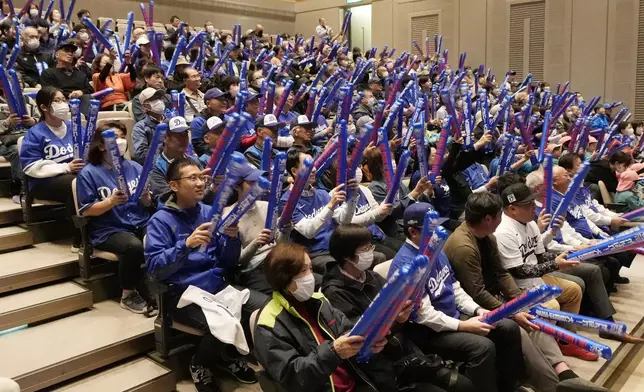 People watch a live stream before the start of Game 3 of the baseball World Series between the Los Angeles Dodgers and the New York Yankees during a public viewing event in Oshu, northeastern Japan, the hometown of Shohei Ohtani of the Dodgers, Tuesday, Oct. 29, 2024. (AP Photo/Eugene Hoshiko)