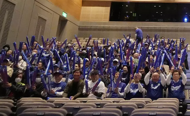 People watch a live stream before the start of Game 3 of the baseball World Series between the Los Angeles Dodgers and the New York Yankees during a public viewing event in Oshu, northeastern Japan, the hometown of Shohei Ohtani of the Dodgers, Tuesday, Oct. 29, 2024. (AP Photo/Eugene Hoshiko)