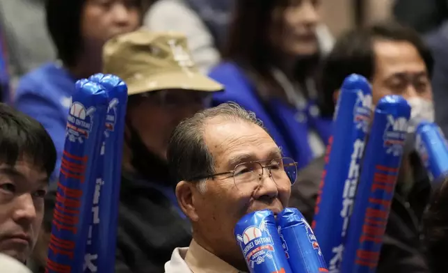 People watch a live stream before the start of Game 3 of the baseball World Series between the Los Angeles Dodgers and the New York Yankees during a public viewing event in Oshu, northeastern Japan, the hometown of Shohei Ohtani of the Dodgers, Tuesday, Oct. 29, 2024. (AP Photo/Eugene Hoshiko)