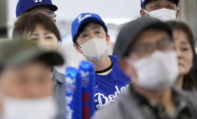 People react as they watch a live view of Game 4 of the baseball World Series between the Los Angeles Dodgers and the New York Yankees during a public viewing event in Oshu, northeastern Japan, the hometown of Shohei Ohtani of the Dodgers, Wednesday, Oct. 30, 2024. (AP Photo/Eugene Hoshiko)