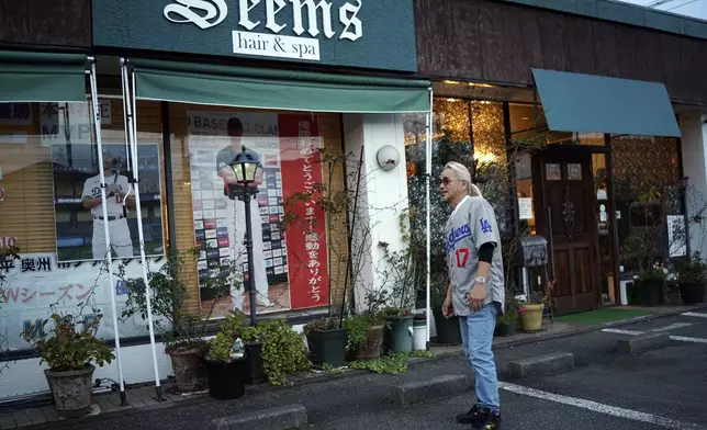 Hironobu Kanno, representative of a private fan club of Shohei Ohtani of the Los Angeles Dodgers, speaks at his beauty salon in Oshu, northeastern Japan, the hometown of Ohtani, Tuesday, Oct. 29, 2024. (AP Photo/Eugene Hoshiko)