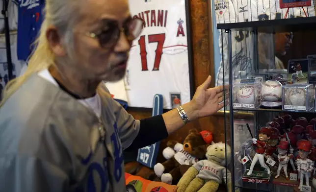 Hironobu Kanno, representative of a private fan club of Shohei Ohtani of the Los Angeles Dodgers, shows his collection items at his beauty salon in Oshu, northeastern Japan, the hometown of Ohtani, Tuesday, Oct. 29, 2024. (AP Photo/Eugene Hoshiko)