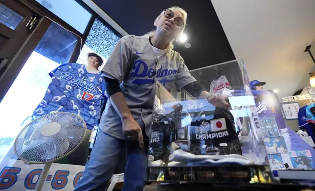 Hironobu Kanno, representative of a private fan club of Shohei Ohtani of the Los Angeles Dodgers, shows his collection items at his beauty salon in Oshu, northeastern Japan, the hometown of Ohtani, Tuesday, Oct. 29, 2024. (AP Photo/Eugene Hoshiko)