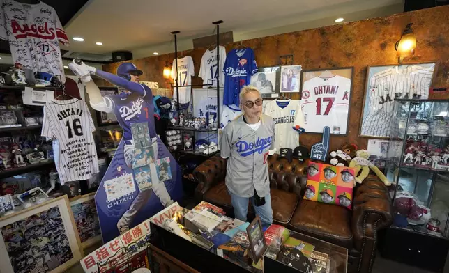 Hironobu Kanno, representative of a private fan club of Shohei Ohtani of the Los Angeles Dodgers, shows his collection items at his beauty salon in Oshu, northeastern Japan, the hometown of Ohtani, Tuesday, Oct. 29, 2024. (AP Photo/Eugene Hoshiko)