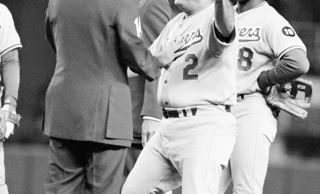FILE - Los Angeles Dodgers manager Tom Lasorda argues with umpire Frank Pulli on a controversial play in seventh inning of aWorld Series game with the New York Yankees in New York, Saturday, Oct. 14, 1978. Lasorda argued possible interference by Yankees Reggie Jackson on a throw to first. At right is Dodgers Reggie Smith. (AP Photo/File)