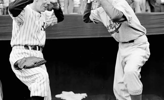 FILE - New York Yankees bat boy Tim Sullivan, left, and Brooklyn Dodgers bat boy Jack Bodner taunt each other as the World Series opened at Yankee Stadium in New York, Oct. 1, 1941. (AP Photo/Tom Sande, File)