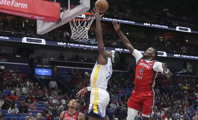 Golden State Warriors guard Buddy Hield (7) goes to the basket against New Orleans Pelicans guard Javonte Green (4) in the first half of an NBA basketball game in New Orleans, Friday, Nov. 22, 2024. (AP Photo/Gerald Herbert)