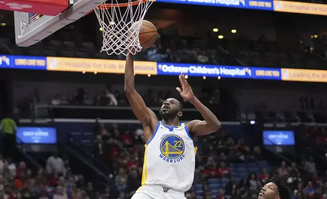 Golden State Warriors forward Andrew Wiggins (22) goes to the basket in the first half of an NBA basketball game against the New Orleans Pelicans in New Orleans, Friday, Nov. 22, 2024. (AP Photo/Gerald Herbert)