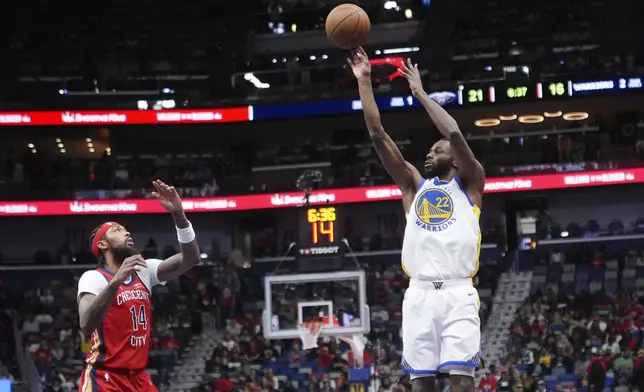 Golden State Warriors forward Andrew Wiggins (22) shoots against New Orleans Pelicans forward Brandon Ingram (14) in the first half of an Emirates NBA Cup basketball game in New Orleans, Friday, Nov. 22, 2024. (AP Photo/Gerald Herbert)