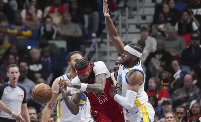 New Orleans Pelicans forward Brandon Ingram (14) loses the ball as he battles between Golden State Warriors forward Kyle Anderson (1) and guard Moses Moody (4) in the first half of an NBA basketball game in New Orleans, Friday, Nov. 22, 2024. (AP Photo/Gerald Herbert)