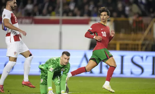 Portugal's Joao Felix celebrates after scoring his side's first goal during the UEFA Nations League soccer match between Croatia and Portugal at Poljud stadium in Split, Croatia, Monday, Nov. 18, 2024. (AP Photo/Darko Bandic)