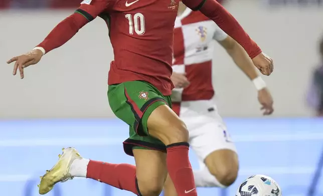 Portugal's Joao Felix scores his side's first goal during the UEFA Nations League soccer match between Croatia and Portugal at Poljud stadium in Split, Croatia, Monday, Nov. 18, 2024. (AP Photo/Darko Bandic)