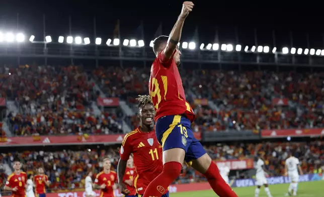 Spain's Yeremy Pino celebrates next to Niko Williams the opening goal during a Nations League soccer match between Spain and Switzerland, at the Heliodoro Rodríguez López stadium in Tenerife, Spain, Monday, Nov. 18, 2024. (AP Photo/Angel Fernandez)