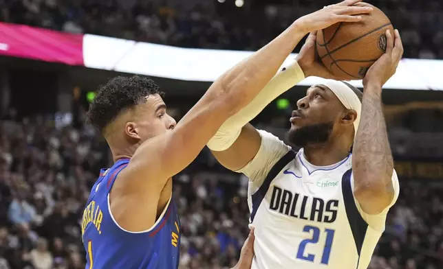 Denver Nuggets forward Michael Porter Jr. (1) pressures Dallas Mavericks center Daniel Gafford (21) during the first half of an Emirates NBA Cup basketball game Friday, Nov. 22, 2024, in Denver. (AP Photo/Jack Dempsey)