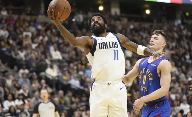 Dallas Mavericks guard Kyrie Irving (11) goes up to shoot against Denver Nuggets guard Christian Braun (0) during the first half of an Emirates NBA Cup basketball game Friday, Nov. 22, 2024, in Denver. (AP Photo/Jack Dempsey)