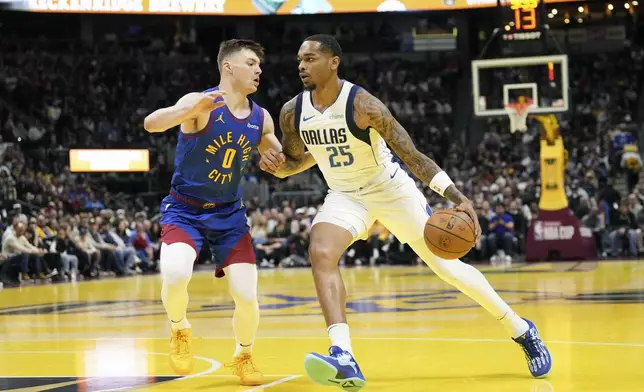 Dallas Mavericks forward P.J. Washington (25) drives to the basket against Denver Nuggets guard Christian Braun (0) during the first half of an Emirates NBA Cup basketball game Friday, Nov. 22, 2024, in Denver. (AP Photo/Jack Dempsey)