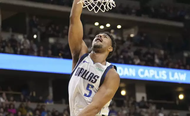 Dallas Mavericks guard Quentin Grimes dunks against the Denver Nuggets during the first half of an Emirates NBA Cup basketball game Friday, Nov. 22, 2024, in Denver. (AP Photo/Jack Dempsey)