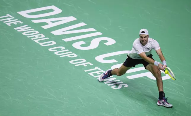 Germany's Jan-Lennard Struff returns the ball to Netherlands' Tallon Griekspoor during the Davis Cup semifinal at the Martin Carpena Sports Hall in Malaga, southern Spain, on Friday, Nov. 22, 2024. (AP Photo/Manu Fernandez)