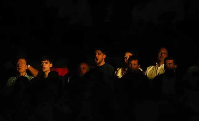 Tennis spectators attend the Davis Cup match between Germany's Daniel Altmaier and Netherlands' Botic Van De Zandschulp at the Martin Carpena Sports Hall in Malaga, southern Spain, on Friday, Nov. 22, 2024. (AP Photo/Manu Fernandez)