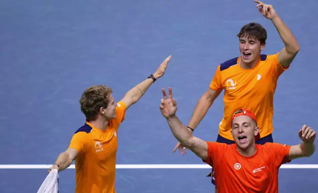 The Netherlands' Davis Cup team celebrates their qualification for the final after defeating Germany at the Martin Carpena Sports Hall in Malaga, southern Spain, on Friday, Nov. 22, 2024. (AP Photo/Manu Fernandez)