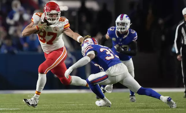 Kansas City Chiefs tight end Travis Kelce (87) runs with the ball as Buffalo Bills cornerback Cam Lewis defends during the second half of an NFL football game Sunday, Nov. 17, 2024, in Orchard Park, N.Y. (AP Photo/Julia Demaree Nikhinson)