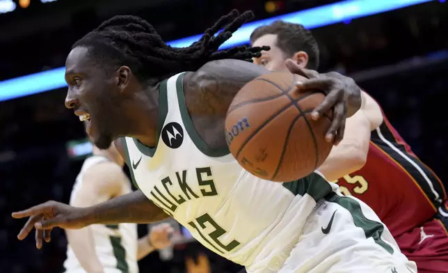 Milwaukee Bucks forward Taurean Prince (12) drives to the basket during the first half of an Emirates NBA Cup basketball game against the Miami Heat, Tuesday, Nov. 26, 2024, in Miami. (AP Photo/Lynne Sladky)