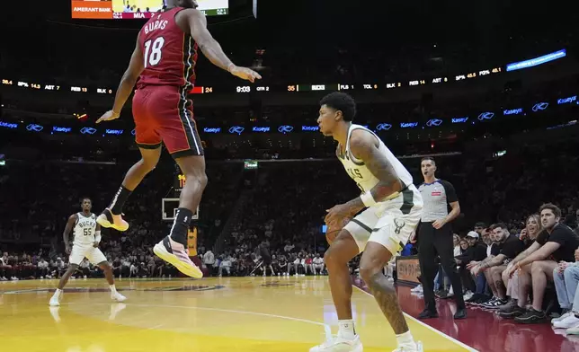 Miami Heat guard Alec Burks (18) defends Milwaukee Bucks forward MarJon Beauchamp, right, during the first half of an Emirates NBA Cup basketball game, Tuesday, Nov. 26, 2024, in Miami. (AP Photo/Lynne Sladky)