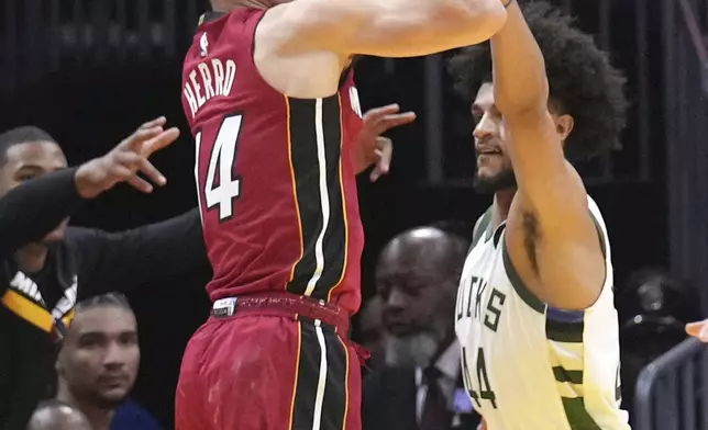 Miami Heat guard Tyler Herro (14) shoots over Milwaukee Bucks guard Andre Jackson Jr. (44) during the first half of an Emirates NBA Cup basketball game, Tuesday, Nov. 26, 2024, in Miami. (AP Photo/Lynne Sladky)