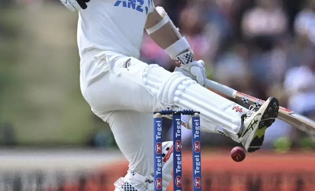 New Zealand's Kane Williamson kicks at the ball during play on the third day of the first cricket test between England and New Zealand at Hagley Oval in Christchurch, New Zealand, Saturday, Nov. 30, 2024. (Andrew Cornaga/Photosport via AP)