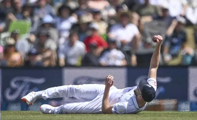 Gus Atkinson of England reacts after taking a catch to dismiss New Zealand's Devon Conway during play on the third day of the first cricket test between England and New Zealand at Hagley Oval in Christchurch, New Zealand, Saturday, Nov. 30, 2024.(John Davidson/Photosport via AP)