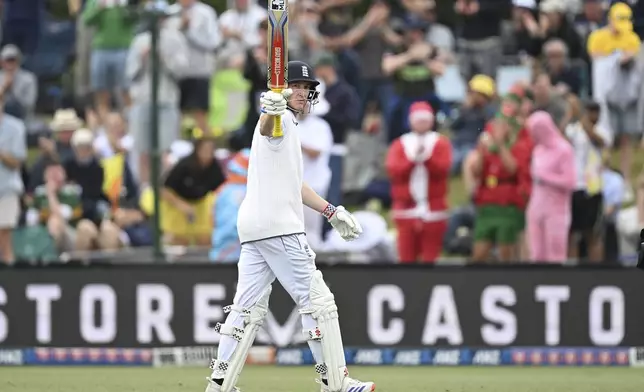 England's Harry Brook gestures to the crowd as he leaves the field after he was dismissed for a 171 runs during play on the third day of the first cricket test between England and New Zealand at Hagley Oval in Christchurch, New Zealand, Saturday, Nov. 30, 2024. (Andrew Cornaga/Photosport via AP)