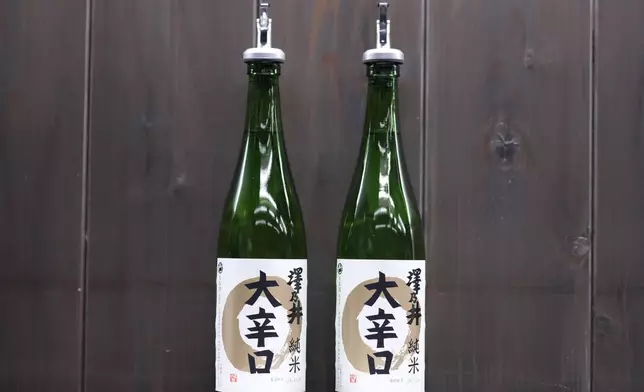 Bottles of Sawanoi, a Japanese sake brand by Ozawa Sake Brewery, are prepared for tasting at a room during a media tour at the brewery in Ome, on the western outskirts of Tokyo, Japan, Wednesday, Nov. 13, 2024. (AP Photo/Hiro Komae)