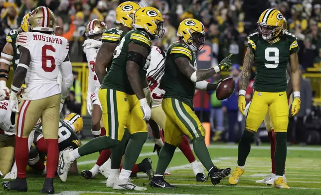 Green Bay Packers running back Josh Jacobs (8) celebrates a touchdown during the second half of an NFL football game against the San Francisco 49ers on Sunday, Nov. 24, 2024 in Green Bay, Wis. (AP Photo/Matt Ludtke)