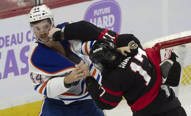 Ottawa Senators right wing Zack MacEwen (17) lands a punch on Edmonton Oilers defenseman Josh Brown (44) as they fight during the first period of an NHL hockey game, Tuesday, Nov. 19, 2024 in Ottawa, Ontario. (Adrian Wyld/The Canadian Press via AP)