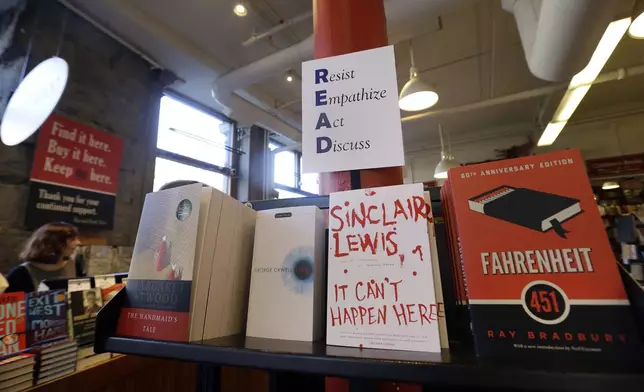 FILE - Books are displayed under a sign at the Harvard Book Store, Thursday, March 9, 2017, in Cambridge, Mass. (AP Photo/Elise Amendola, File)