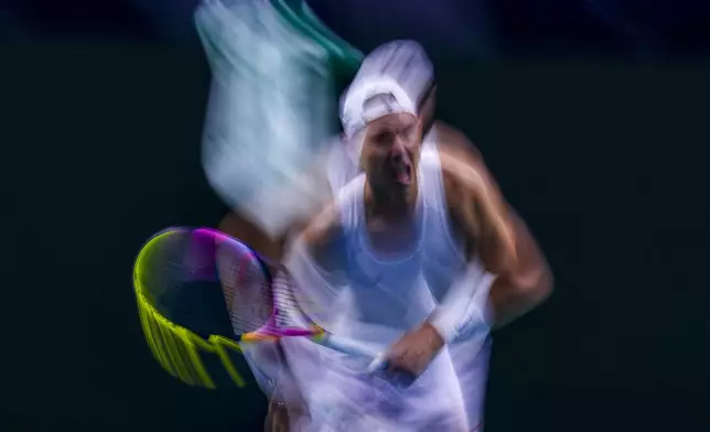 In this image taken with a slow shutter speed, Spain's tennis player Rafael Nadal gestures during a training session at the Martin Carpena Sports Hall, in Malaga, southern Spain, on Friday, Nov. 15, 2024. (AP Photo/Manu Fernandez)