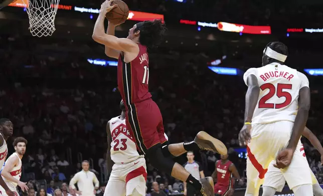 Miami Heat guard Jaime Jaquez Jr. (11) goes to the basket during the first half of an Emirates NBA Cup basketball game against the Toronto Raptors, Friday, Nov. 29, 2024, in Miami. (AP Photo/Lynne Sladky)