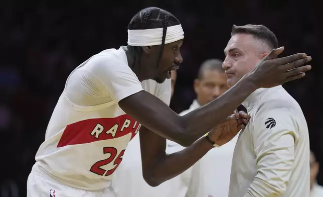 Toronto Raptors forward Chris Boucher (25) talks with head coach Darko Rajakovic during the first half of an Emirates NBA Cup basketball game against the Miami Heat, Friday, Nov. 29, 2024, in Miami. (AP Photo/Lynne Sladky)