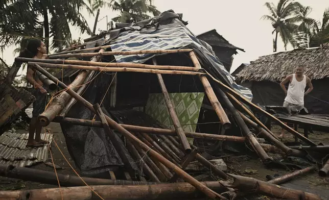 A resident checks his damaged home that was blown off by strong winds caused by Typhoon Man-yi in the municipality of Baler, Aurora province, northeastern Philippines Monday, Nov. 18, 2024. (AP Photo/Noel Celis)