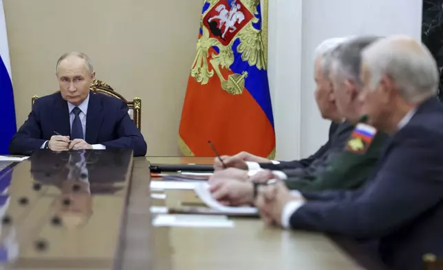 FILE - Russian President Vladimir Putin, left, speaks during a meeting with the leadership of the Russian Ministry of Defense, representatives of the military-industrial complex and developers of missile systems at the Kremlin in Moscow, Russia, Friday, Nov. 22, 2024. (Gavriil Grigorov, Sputnik, Kremlin Pool Photo via AP, File)