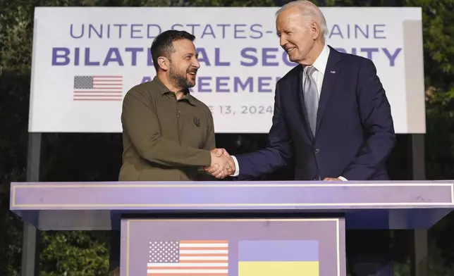 FILE - President Joe Biden and Ukrainian President Volodymyr Zelenskyy shake hands after signing a security agreement on the sidelines of the G7, Thursday, June 13, 2024, in Savelletri, Italy. (AP Photo/Alex Brandon, File)