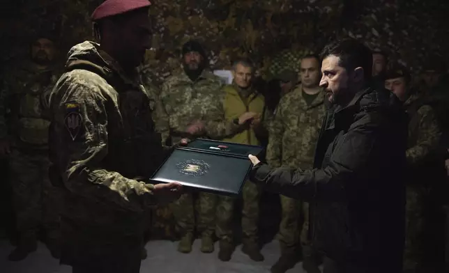 In this photo provided by the Ukrainian Presidential Press Office, Ukrainian President Volodymyr Zelenskyy awards servicemen in the frontline city of Pokrovsk, the site of heaviest battles with the Russian troops in the Donetsk region, Ukraine, Monday, Nov. 18, 2024. (Ukrainian Presidential Press Office via AP)