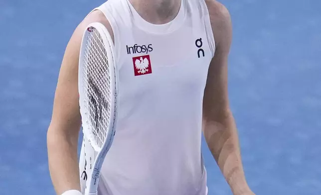 Poland's Iga Swiatek reacts during the Billie Jean King Cup semi-final tennis match against Italy's Jasmine Paolini at Martin Carpena Sports Hall in Malaga, southern Spain, on Monday, Nov. 18, 2024. (AP Photo/Manu Fernandez)