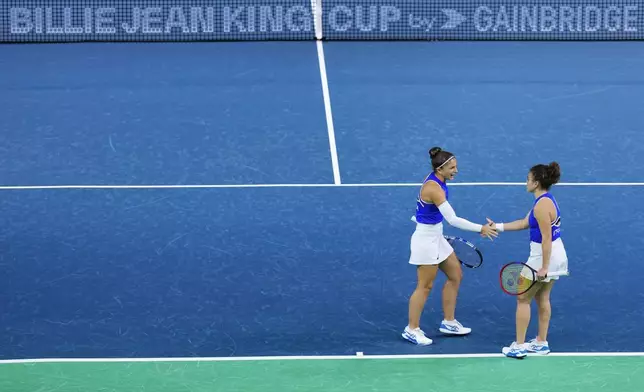 Italy's Sara Errani and Jasmine Paolini, right, compete against Poland's Katarzyna Kawa and Iga Swiatek during the Billie Jean King Cup semi-final at Martin Carpena Sports Hall in Malaga, southern Spain, on Monday, Nov. 18, 2024. (AP Photo/Manu Fernandez)