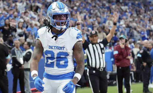 Detroit Lions running back Jahmyr Gibbs (26) reacts after his 5-yard rushing touchdown during the second half of an NFL football game against the Indianapolis Colts, Sunday, Nov. 24, 2024, in Indianapolis. (AP Photo/AJ Mast)