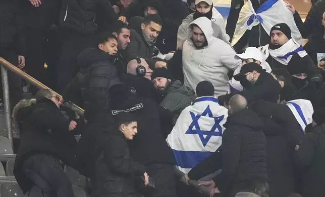 Fans argue on stands during the UEFA Nations League soccer match between France and Israel at the Stade de France stadium in Saint-Denis, outside Paris, Thursday Nov. 14, 2024. (AP Photo/Thibault Camus)