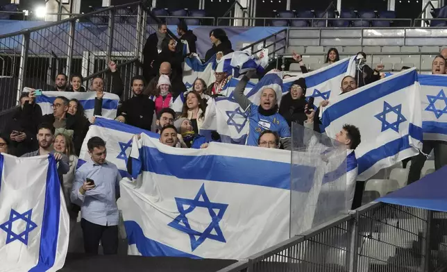 Israeli supporters display their national flag before the UEFA Nations League soccer match between France and Israel at the Stade de France stadium in Saint-Denis, outside Paris, Thursday Nov. 14, 2024. (AP Photo/Michel Euler)