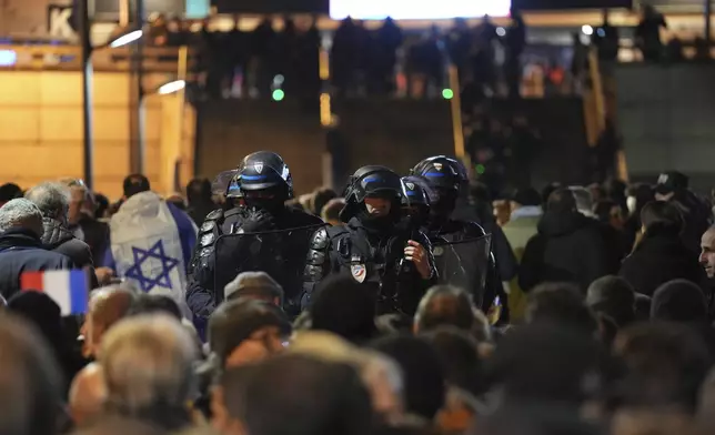 Police officers watch spectators arriving ahead of the Nations League soccer match France against Israel outside the Stade de France stadium, Thursday, Nov. 14, 2024 in Saint-Denis, outside Paris. (AP Photo/Aurelien Morissard)